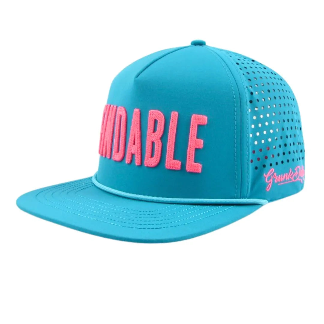 The Blue Findable Hat by Grunk Dolfer is a bright turquoise snapback with KINDABLE in large pink letters, side ventilation holes, “Grunk Dulux” in pink script, waterproof fabric, and a ball marker holder for golfers.