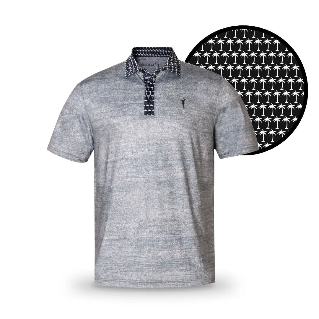 Show your wild side with the Grunk Dolfer Grey Palm Pop—a light gray short-sleeve polo featuring a dark collar, placket, and subtle white palm tree print. A magnified detail highlights the unique pattern beside the shirt.