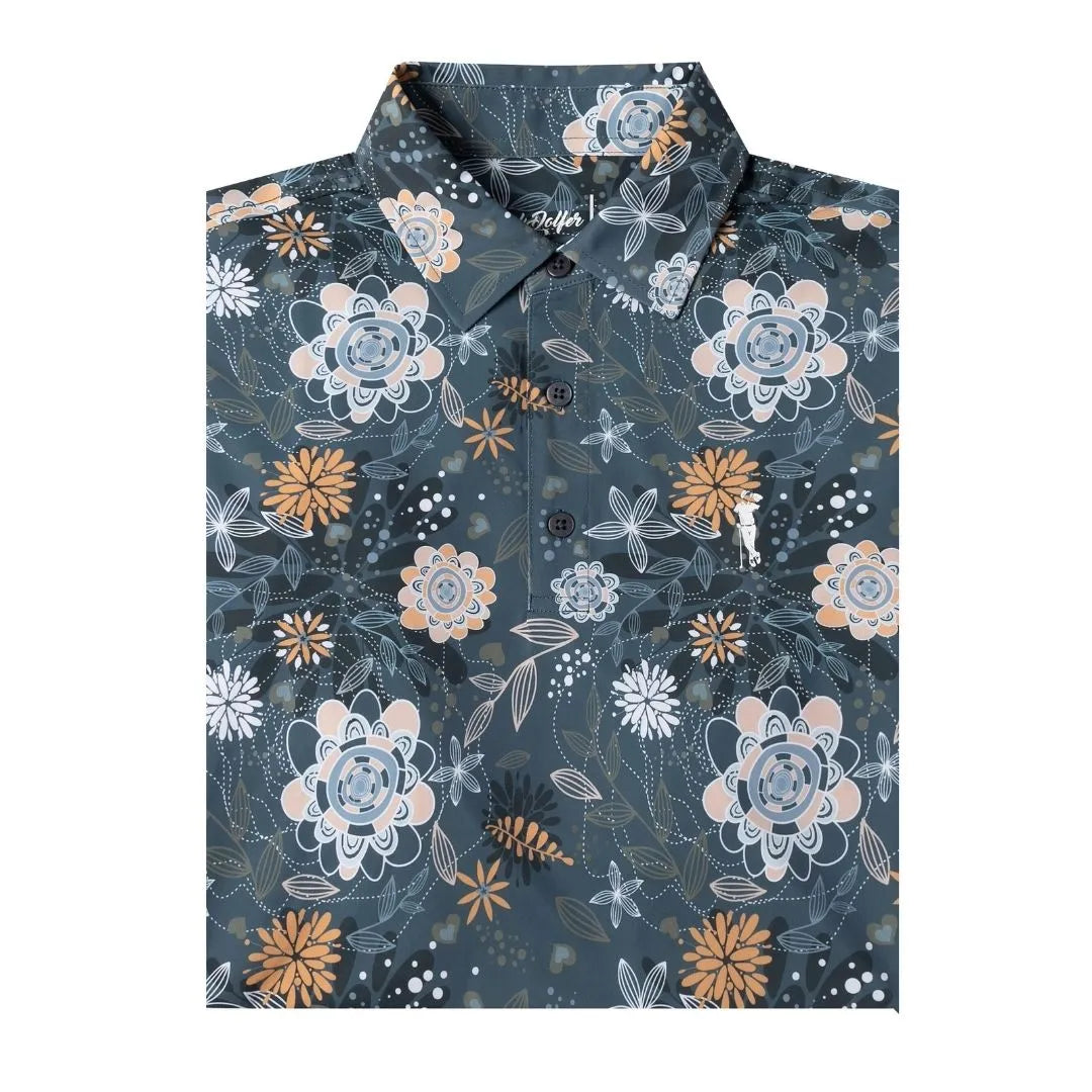Grunk Dolfer’s “Harvest Fairway” button-up shirt features a dark background with blue, white, beige, and orange floral patterns—perfect for refreshing your fall style. The neatly folded shirt highlights its collar and front buttons.