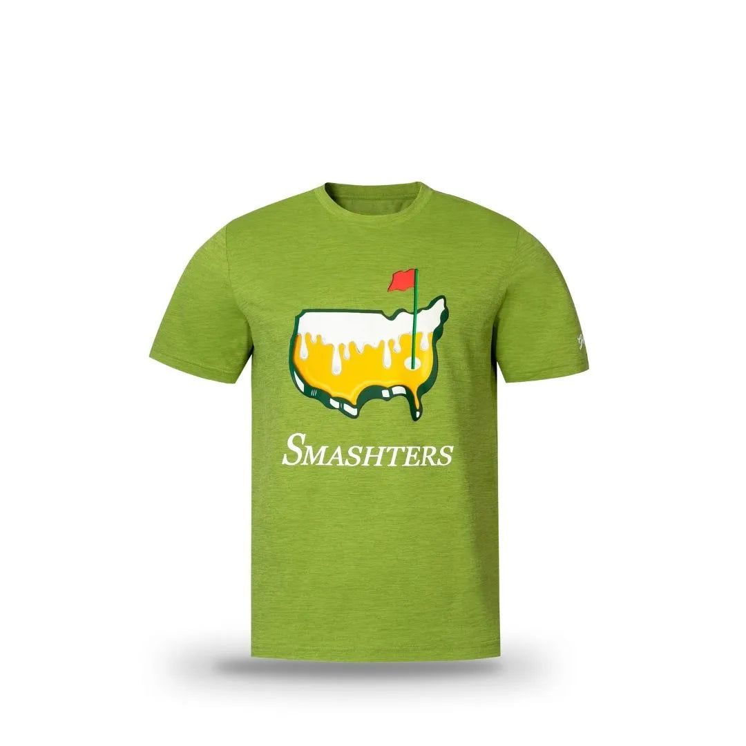 The Grunk Dolfer Smashters Tee is a green golf shirt with an outline of the continental US covered in yellow and white sauce, a small red flag on the right, and "SMASHTERS" printed below the graphic. Tournament-inspired style.