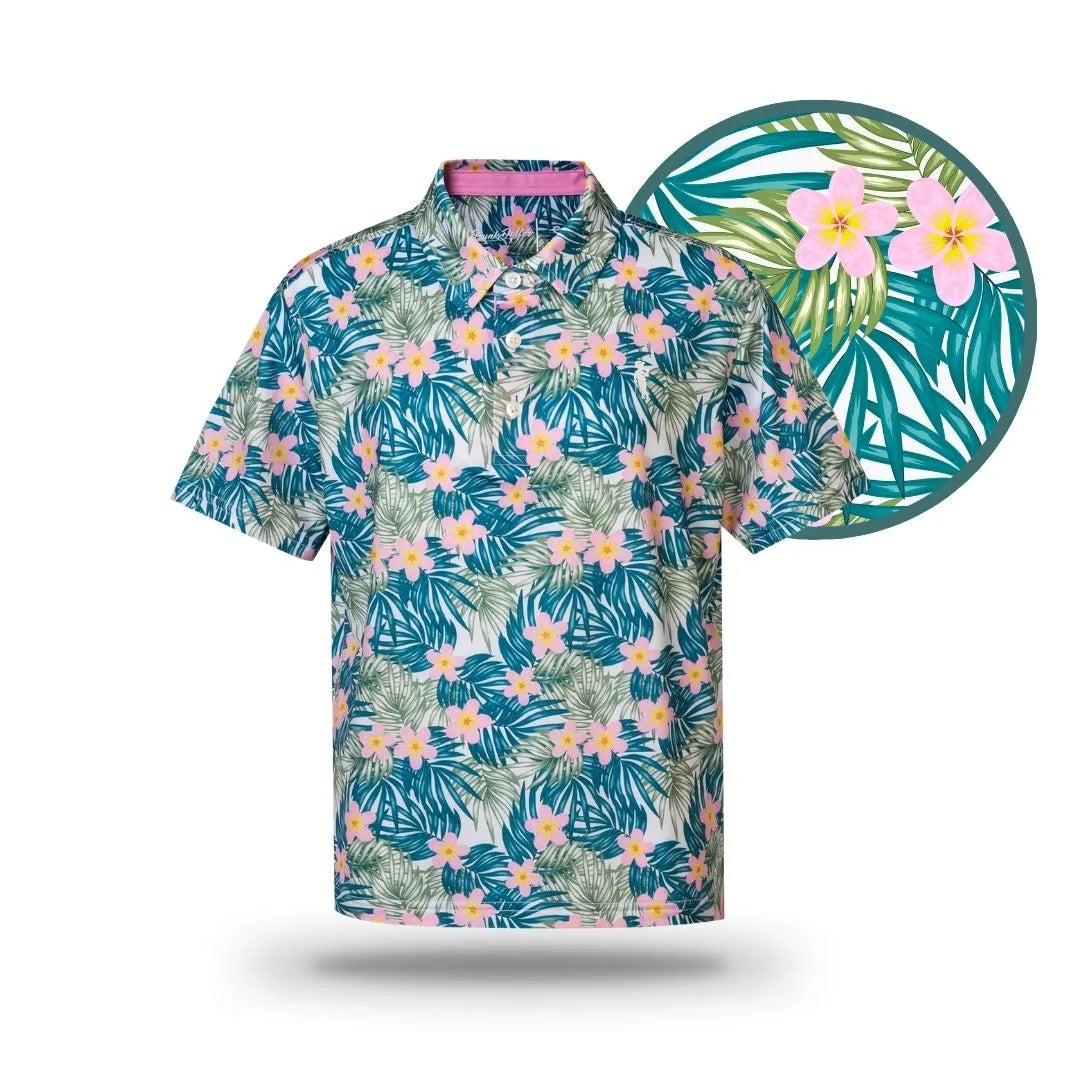 The Grunk Dolfer Kids Island Boy is a short-sleeved button-up with a tropical floral print of green palms and pink-yellow flowers. A close-up highlights the coastal life design, perfect for any beach-ready adventure.