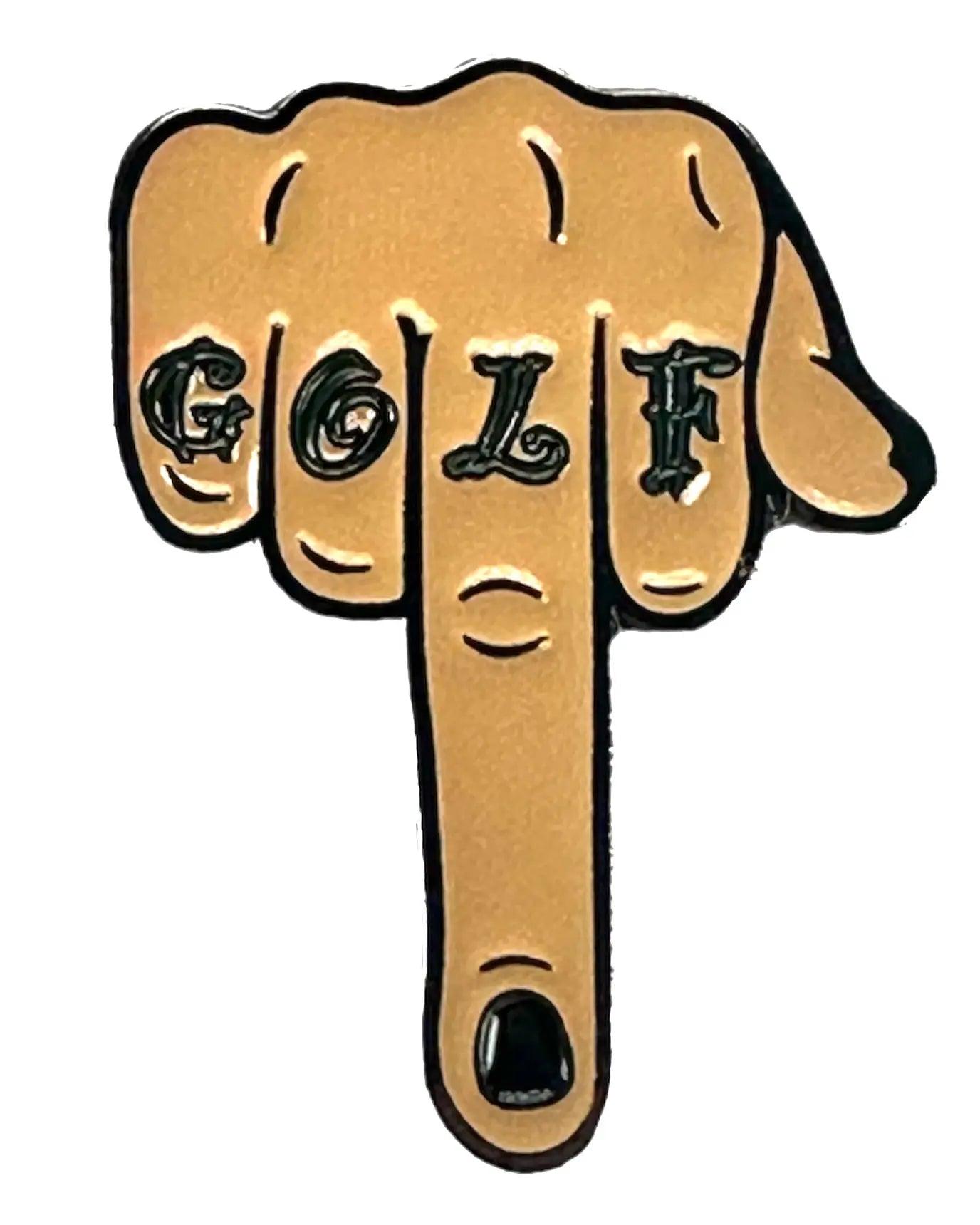 The Eff Golf Ball Marker by Grunk Dolfer features a hand flipping the bird, with GOLF tattooed on the fingers and a discreet golf ball marker among them—an edgy, unique accessory for golf fans. The background is white.