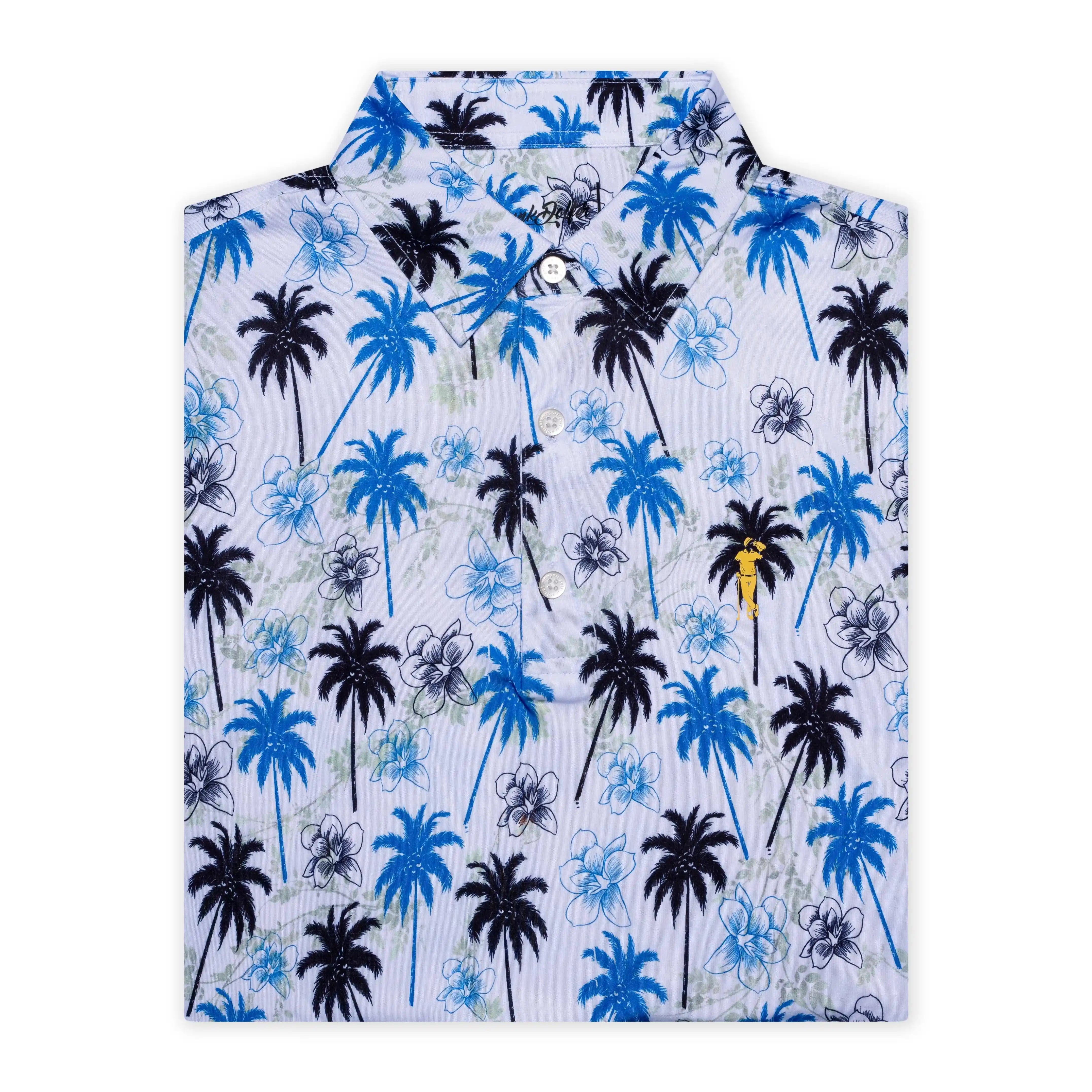 The Grunk Dolfer Fairway Palms is a folded collared golf shirt with a white base, blue and black palm trees, blue and gray flowers, and a small yellow logo in a tropical pattern.