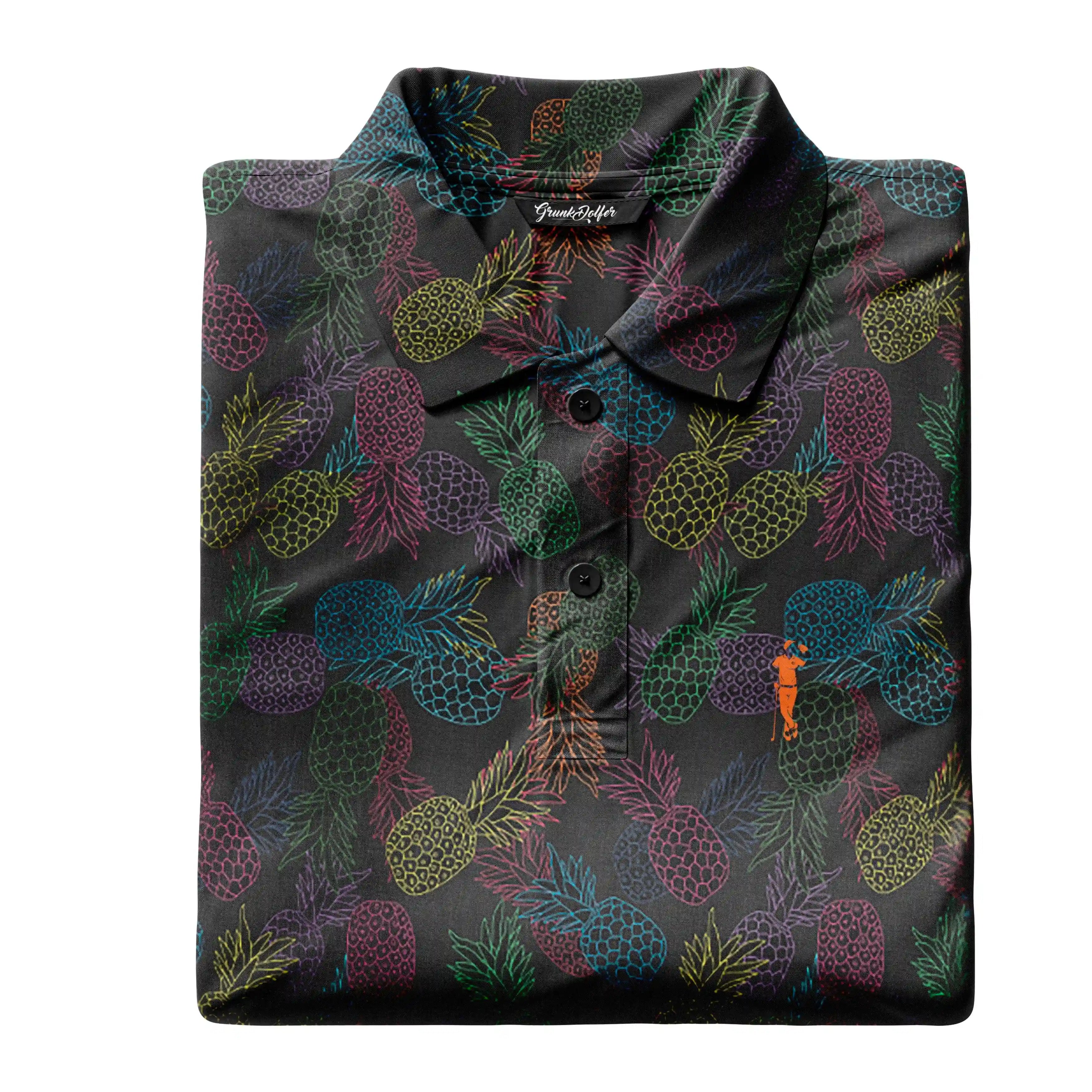 The Grunk Dolfer Midnight Pineapple Sexpress polo, folded on a black background, showcases vibrant red, green, blue, and yellow pineapple outlines with an orange embroidered logo near the lower right button.