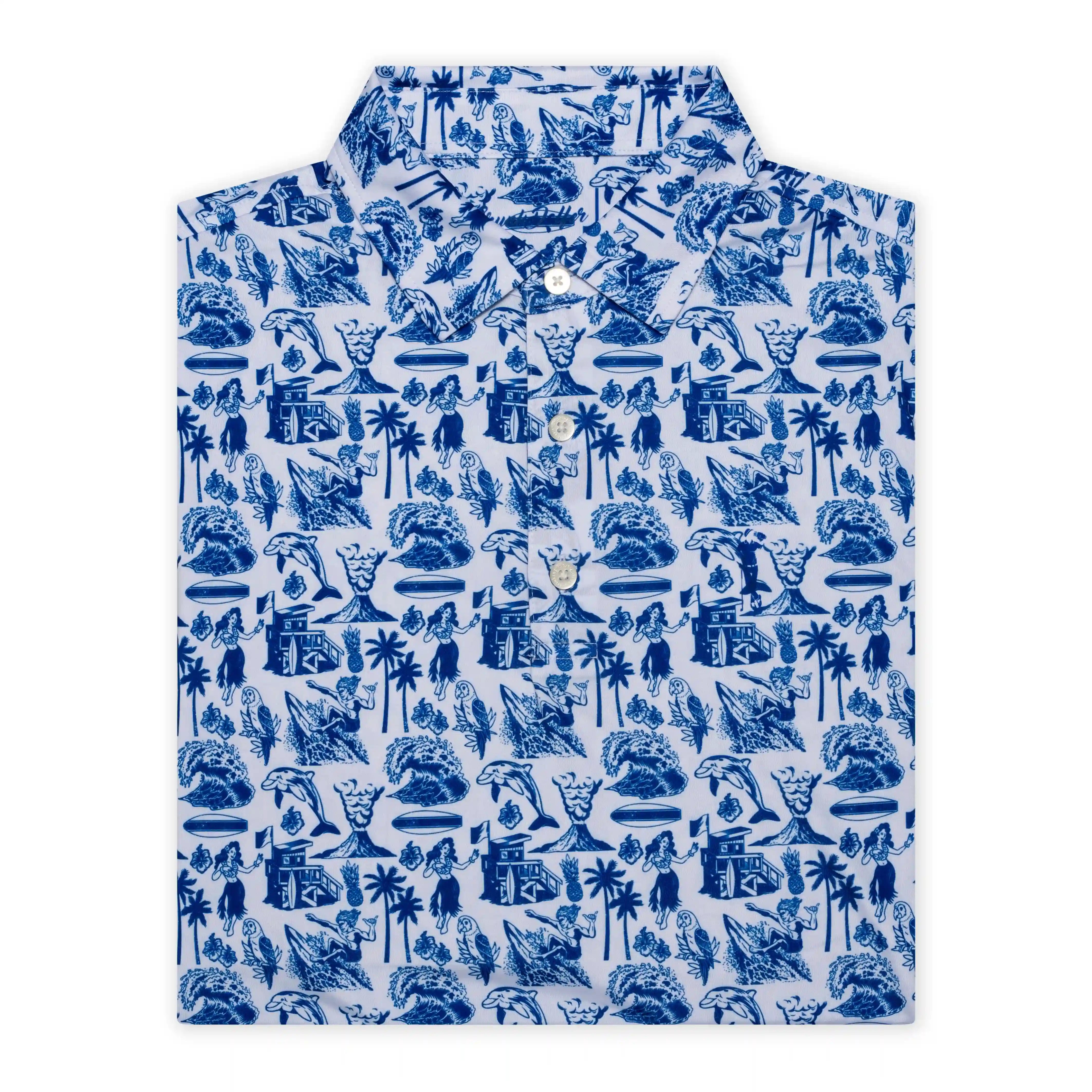 The White Hawaiian by Grunk Dolfer is a crisp white golf polo with blue palm trees, surfers, waves, huts, and people—a tropical shirt perfect for standout style on the course.