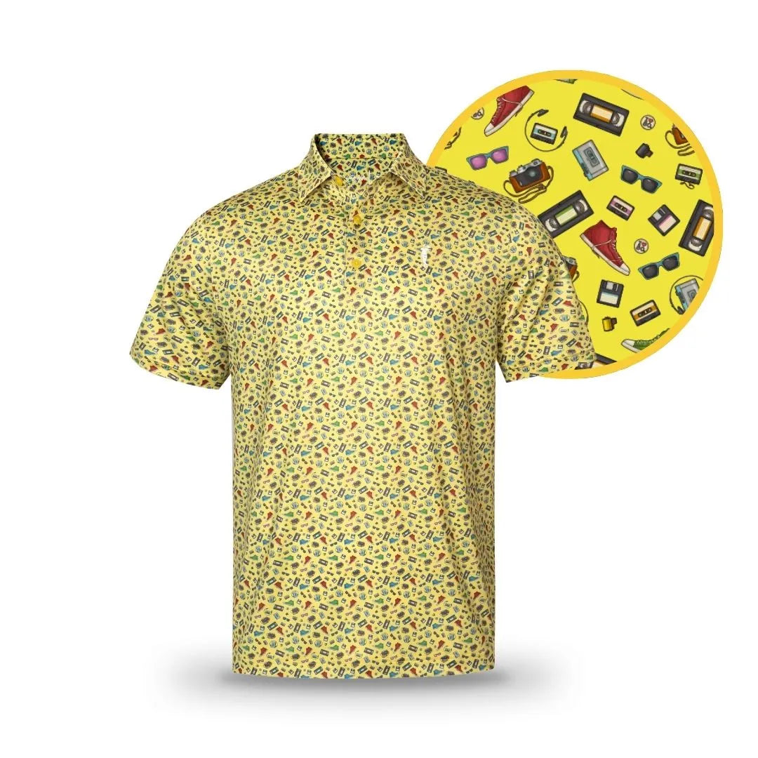 The 90's Baby by Grunk Dolfer is a vibrant yellow short-sleeve polo with playful retro icon prints, including cassette tapes, sunglasses, sneakers, cameras, and dollar bills.