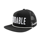 The Findable Hat by Grunk Dolfer is a black golf hat with a curved brim, FINDABLE in bold white letters on the front, Grungy Gentleman in white script on the side, and perforated back panels for comfort.