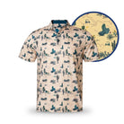 The Grunk Dolfer Desert Classic is a short-sleeve polo with a beige Southwestern desert pattern—cacti, mountains, shrubs—and a circular inset showing fabric details. Ideal for golf apparel with its timeless design.