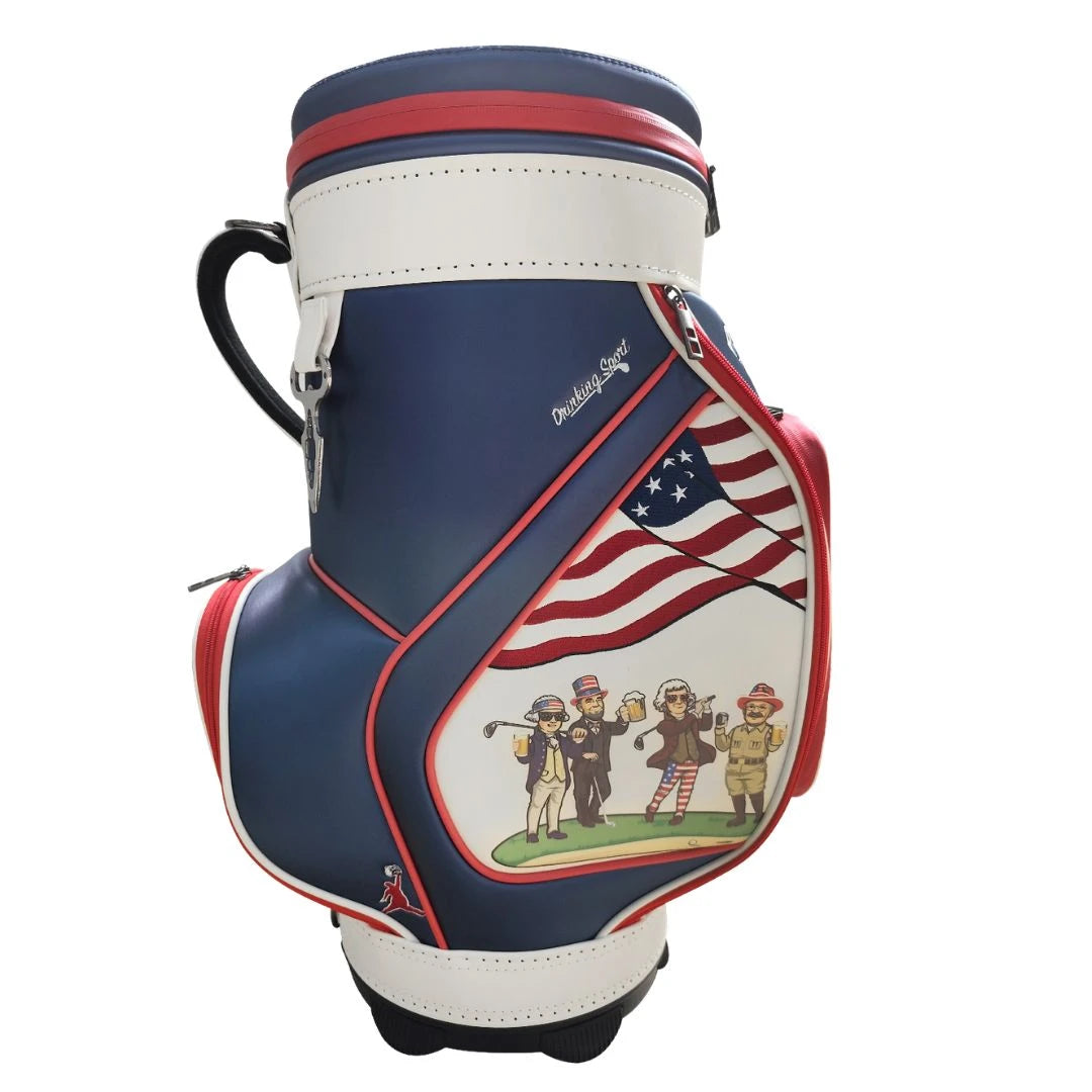 The Grunk Dolfer Grunk Fathers Den Caddy is a navy, white, and red American flag golf bag with four cartoon golfers, red accents, a top handle, and a built-in insulated beer cooler to keep drinks cold on the course.