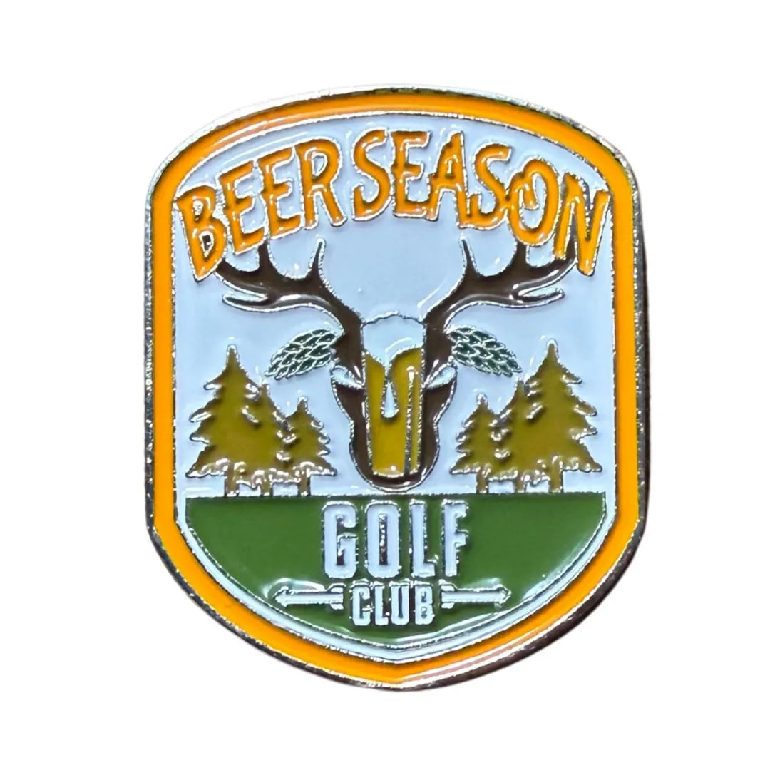 The Grunk Dolfer Beer Season Ball Marker features "BEER SEASON" above a deer skull with antlers, two trees, and "GOLF CLUB" below on a yellow-edged badge—ideal for golf gifts or attaching to a magnetic hat clip.