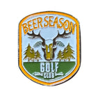 The Grunk Dolfer Beer Season Ball Marker features "BEER SEASON" above a deer skull with antlers, two trees, and "GOLF CLUB" below on a yellow-edged badge—ideal for golf gifts or attaching to a magnetic hat clip.