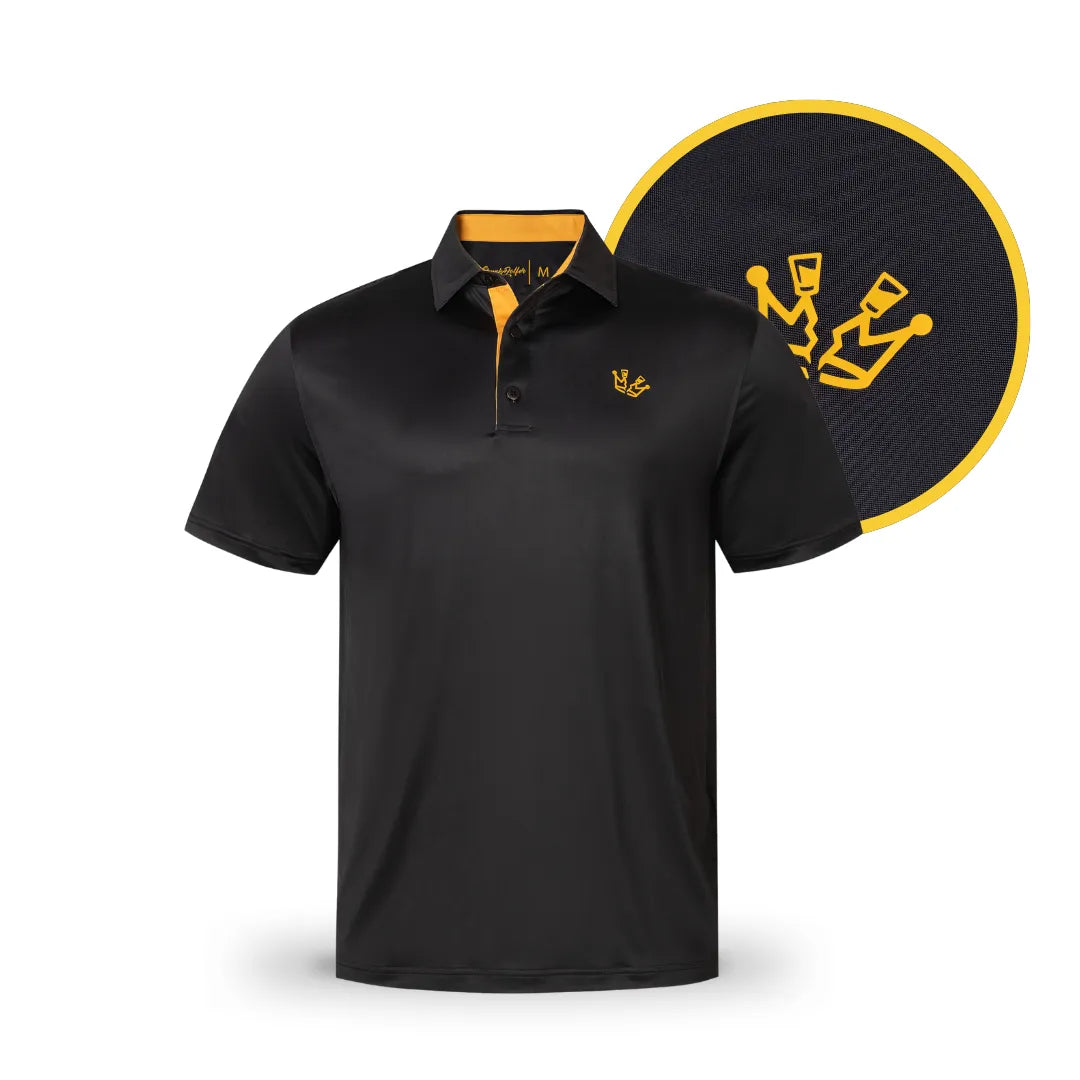 The Grunk Dolfer Black Shotty is a minimalist black polo with yellow collar accents and an embroidered crown emblem on the left chest, shown in detail by a circular close-up of the crown logo.