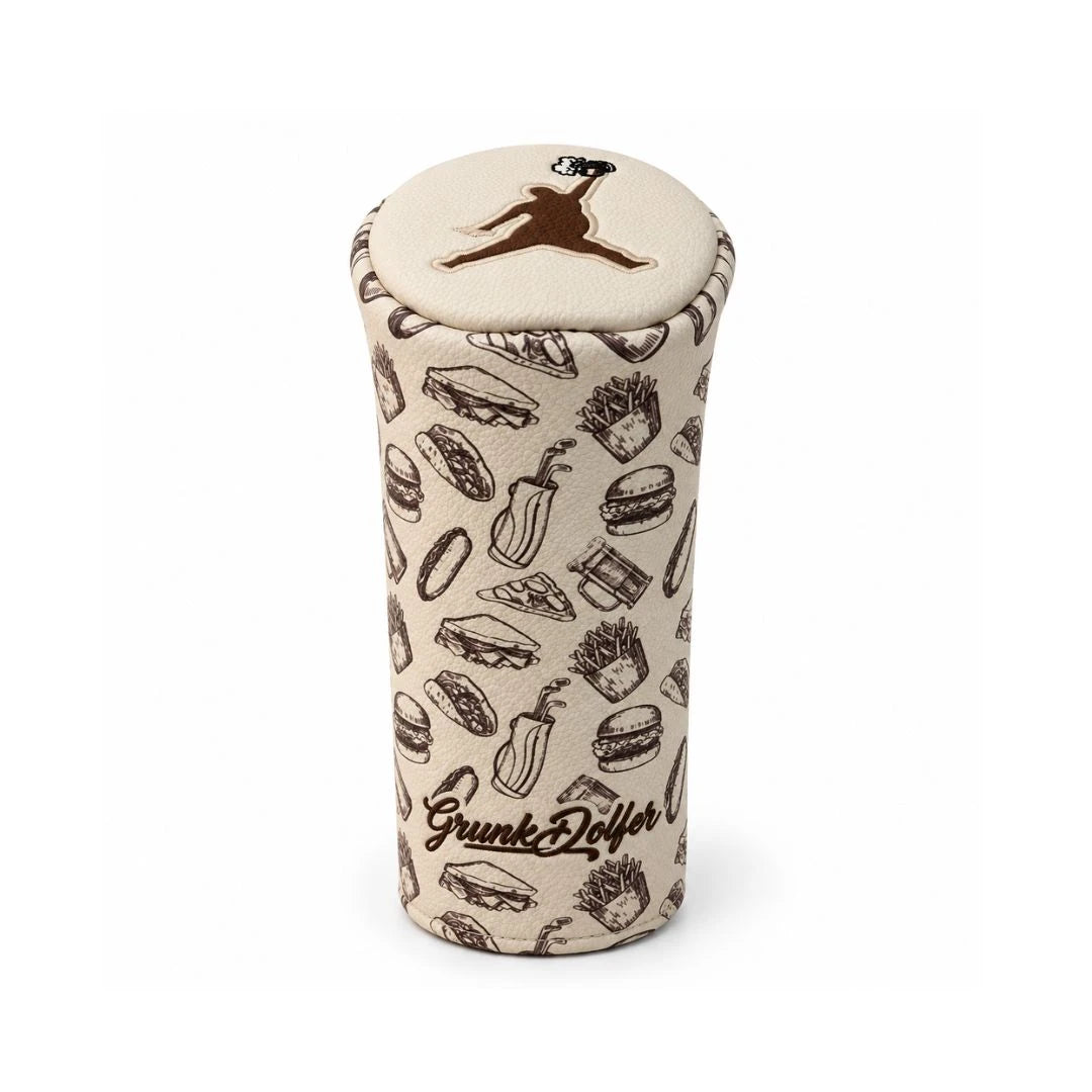 Introducing the Grunk Dolfer Brown Chunkman Barrel Driver Cover—a beige headcover adorned with a whimsical burger pattern, featuring illustrations of burgers, fries, and hot dogs. The top displays a brown jumping figure, while “Grunk Dolfer” is embroidered in brown on the front. This playful driver cover brings personality to your golf bag and keeps your clubs protected.
