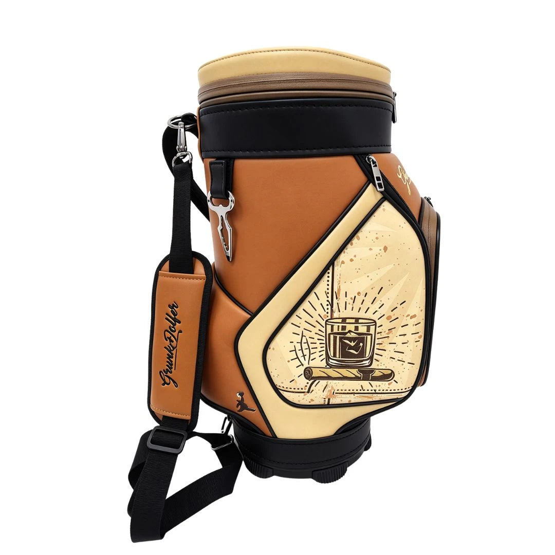 A brown and cream Grunk Dolfer Whiskey Barrel Club Den Caddy featuring an illustration of a glass of whiskey and a cigar on its side pocket, with a matching shoulder strap perfect for storage.