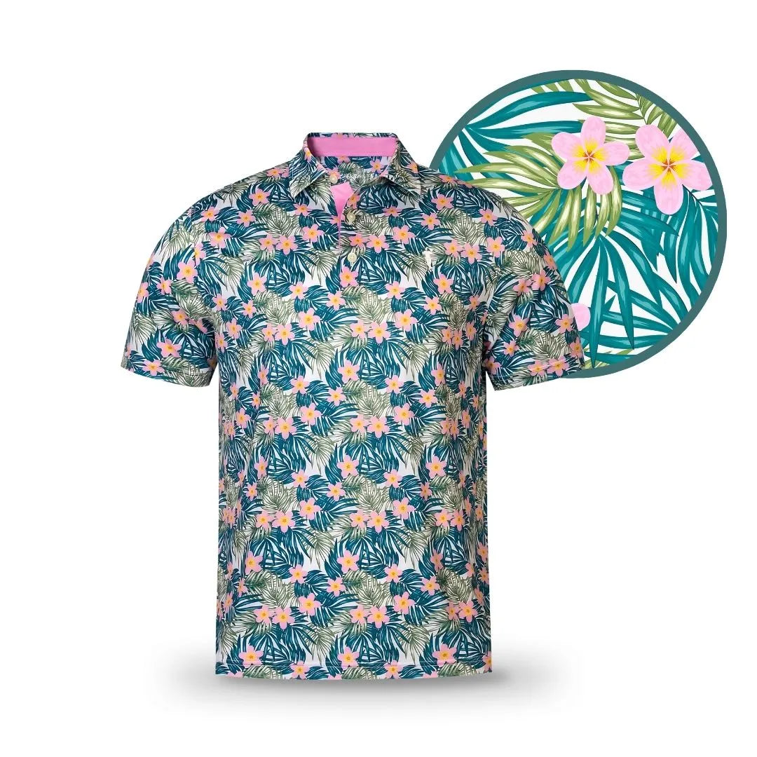 The Island Boy by Grunk Dolfer is a short-sleeved golf polo with a vibrant tropical pattern of pink and yellow flowers plus green palm leaves—perfect for your next round. An enlarged close-up showcases its bold floral and leafy design.