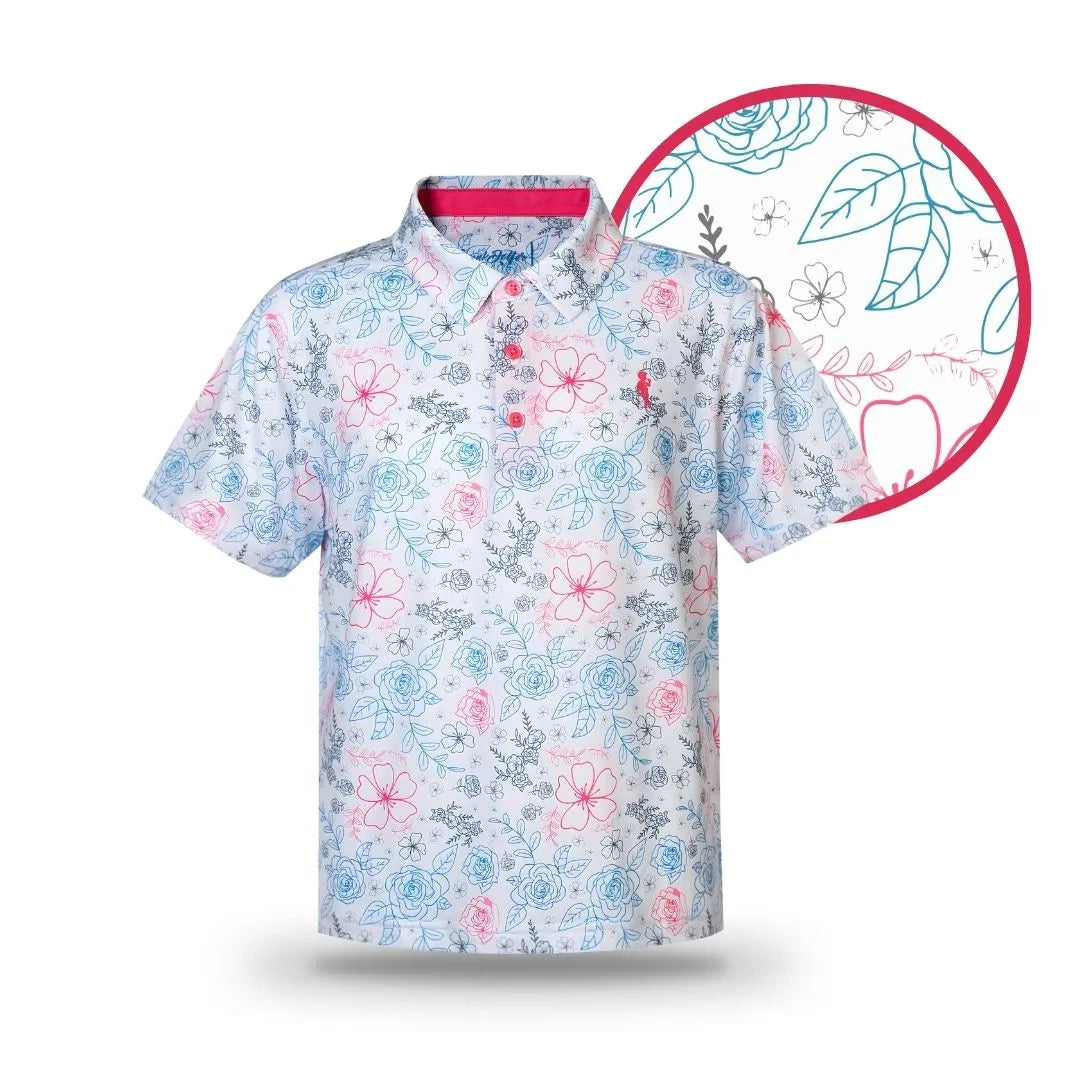 The Grunk Dolfer Kids White Neon Rose short-sleeve polo features a light blue and pink floral pattern, collar, and buttons—ideal for matching dad and kid outfits, with a close-up inset of the vibrant flower and leaf design.