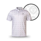 The Grunk Dolfer Tribal Turtle is a short-sleeve, light-colored golf polo with a collar and chest logo, featuring a quirky geometric turtle pattern. A circular inset displays the detailed turtle motif.