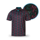 The Neon Rose polo by Grunk Dolfer features short sleeves, a button-up front, and a dark base with an all-over pink and teal floral pattern. A circular close-up highlights its quirky design—perfect for elevating your wardrobe.