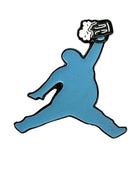 A blue silhouette of a person jumping, holding a frothy beer mug instead of a basketball—the ChunkMan Ball Marker by Grunk Dolfer is perfect for fans of funny golf accessories or unique golf gifts.