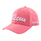The Pink Tittees hat by Grunk Dolfer features bold white script on the front and subtle Grunk Dolfer branding on the side—a playful addition to any golf round.