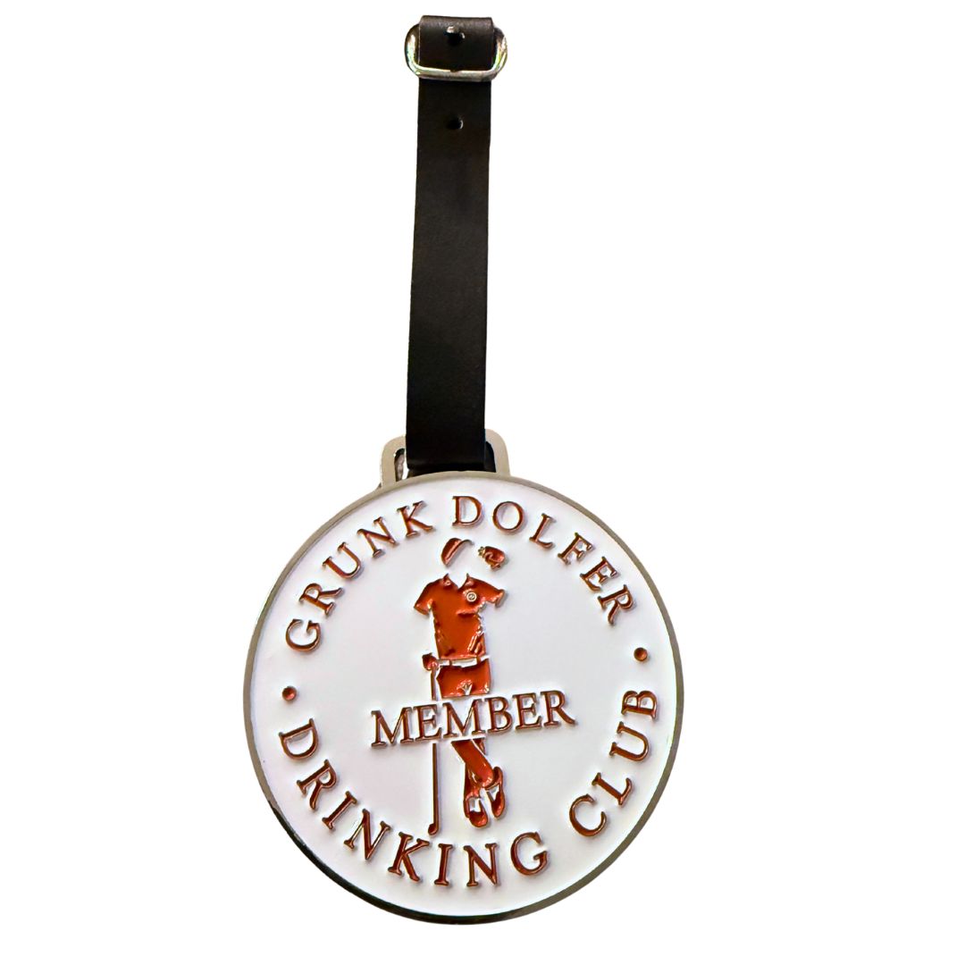The Grunk Dolfer Drinking Club Member Bag Tag is a round, exclusive luggage tag with a belt strap featuring "DRINKING CLUB MEMBER" and an embossed red image of a person leaning on a cane and holding a drink.