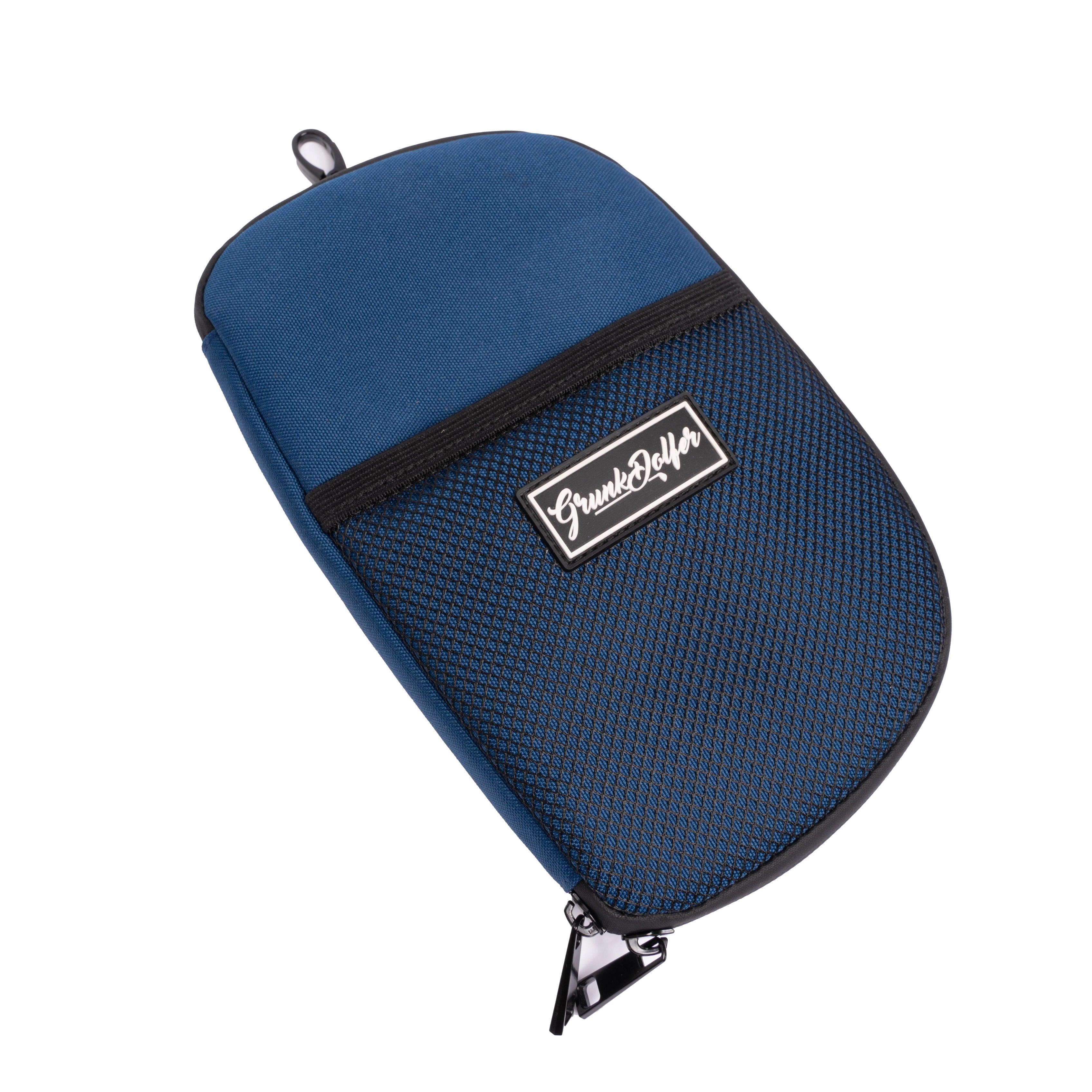 The Grunk Accessory Bag by Grunk Dolfer features a blue zippered pouch with a black mesh front pocket, top loop, and branded patch—ideal for organizing golf accessories in your men’s golf bag or using as a compact golf purse.