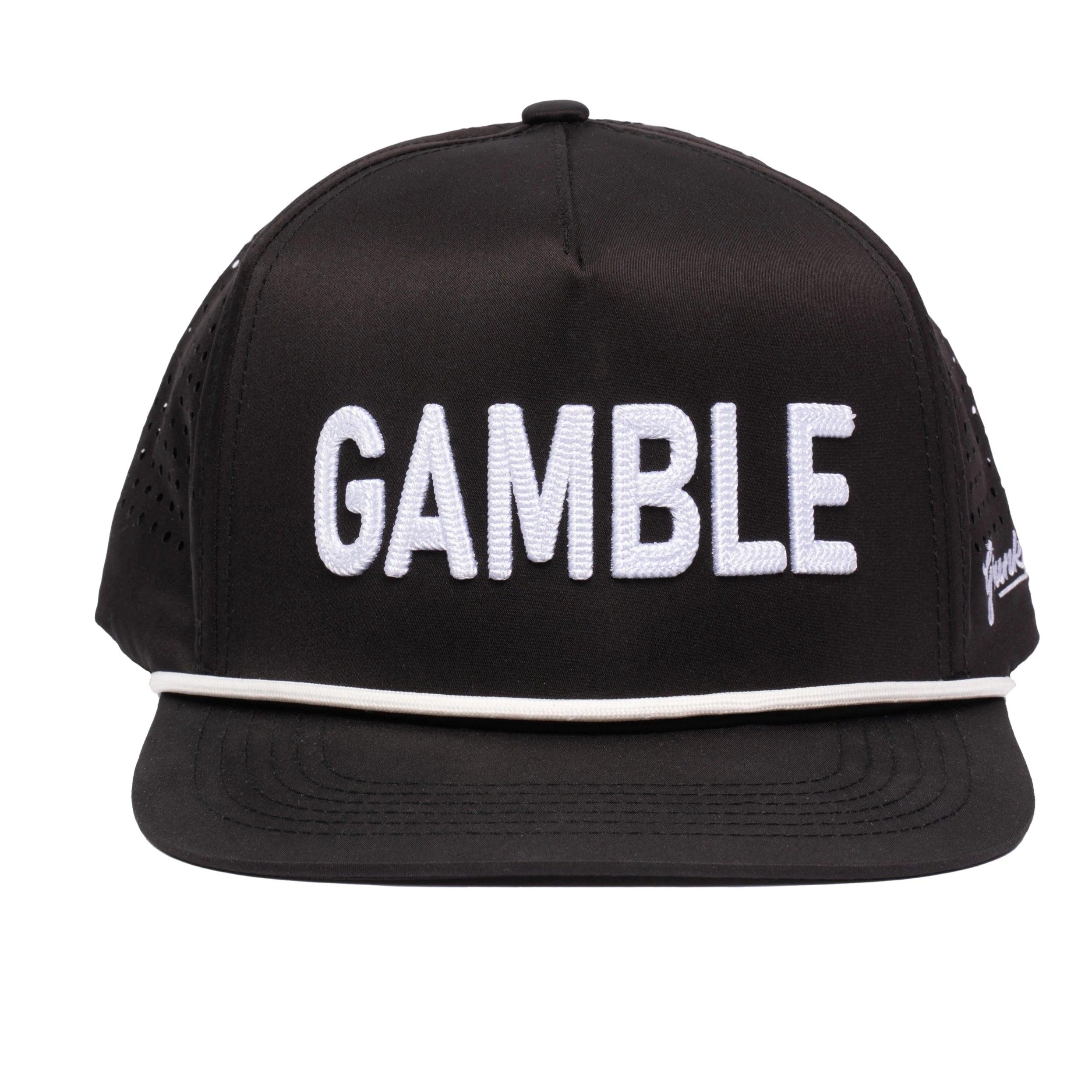 The Grunk Dolfer Grunk Gamble Hat is a black snapback featuring bold white GAMBLE embroidery on the front and a white-trimmed brim, offering breathable comfort for golf or daily wear.
