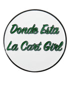 The Grunk Dolfer Donde Esta Ball Marker is a round white marker with green text outlined in black reading Donde Esta La Cart Girl. It adds fun to your golf gear and conveniently attaches to a magnetic hat clip.